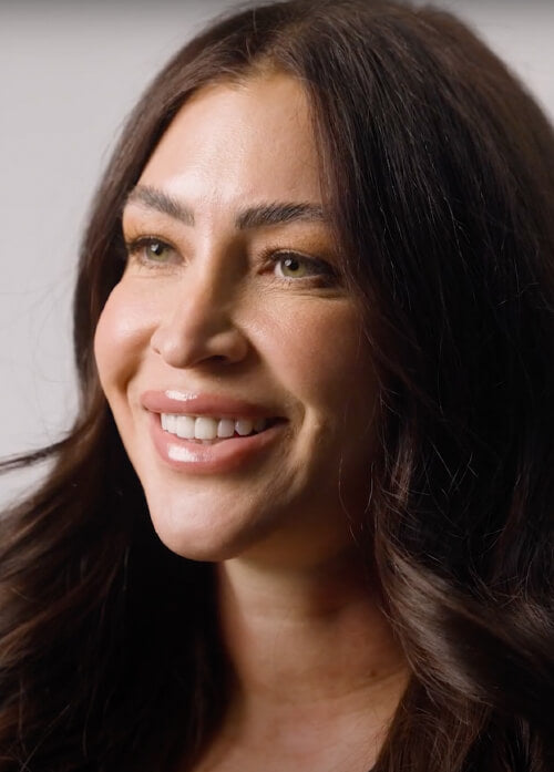 A headshot of a women wearing a block shirt