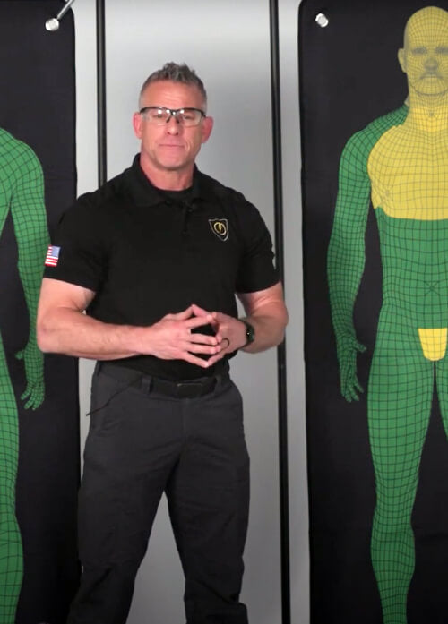 A man standing next to a mannequin 